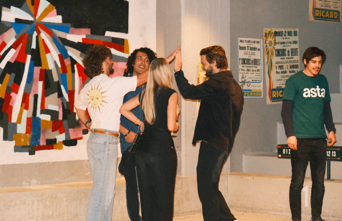 Asta Community Night #1 — a high-five in front of a mural